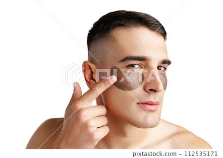 Portrait of attractive young male model with eye patches on white background 112535171
