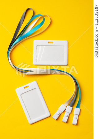 Blank badge with string on yellow background 112535187