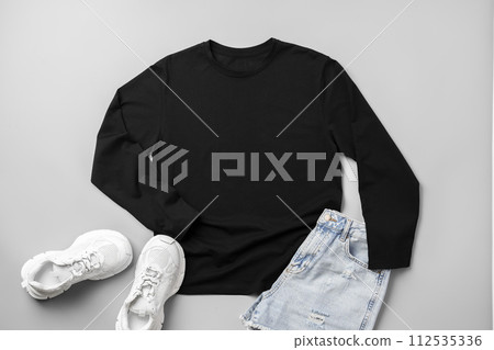 T-shirt, jeans and white sneakers on gray background top view 112535336