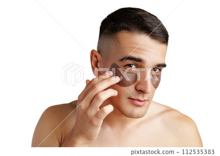 Portrait of attractive young male model with eye patches on white background Portrait of attractive young male model with eye patches on white background 112535383