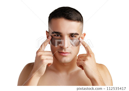 Portrait of attractive young male model with eye patches on white background 112535417