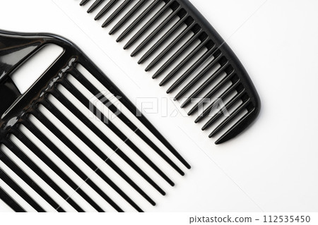 Black plastic hair comb isolated on white background Black plastic hair comb isolated on white background 112535450