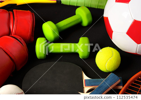 Various sports equipment on black background studio shot Various sports equipment on black background studio shot 112535474