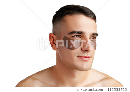 Portrait of attractive young male model with eye patches on white background Portrait of attractive young male model with eye patches on white background 112535713