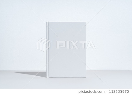 White notepad with hard cover on gray background 112535970