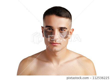 Portrait of attractive young male model with eye patches on white background Portrait of attractive young male model with eye patches on white background 112536225