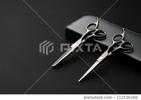 Hairdressing scissors with case on a black background Hairdressing scissors with case on a black background 112536266