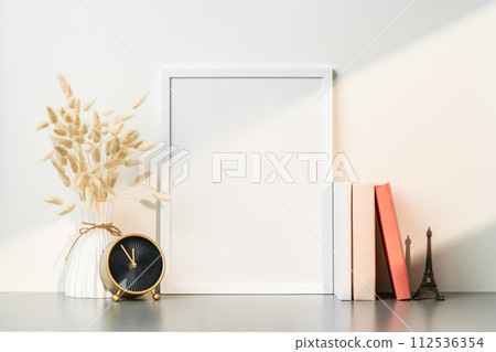 Blank picture frame and dried flower in a vase on white background Blank picture frame and dried flower in a vase on white background 112536354