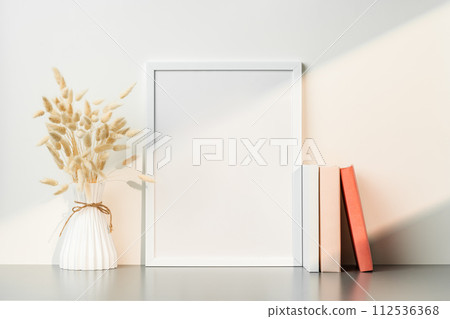 Blank picture frame and dried flower in a vase on white background Blank picture frame and dried flower in a vase on white background 112536368