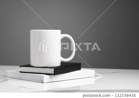 Ceramic mug on marble table on gray background 112536438