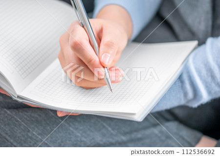 Business and self-education concept. Writes in a notepad. 112536692