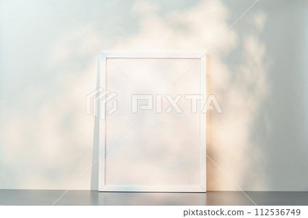 White wooden frame mock up on desk near white wall 112536749