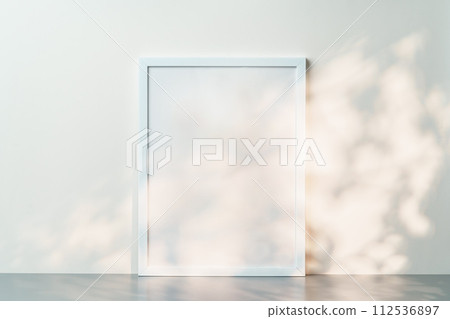 White wooden frame mock up on desk near white wall White wooden frame mock up on desk near white wall 112536897