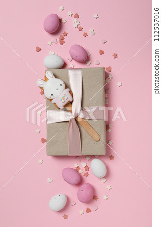 Chocolate eggs with gifts on a pink background 112537016