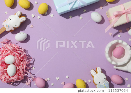 Chocolate eggs in a decorative nest with gifts 112537034