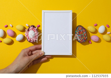 Chocolate eggs with a white blank plate Chocolate eggs with a white blank plate 112537035