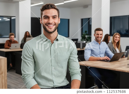 AI-generated content. A man in a sage green shirt stands confidently in the office with his team in the background. 112537686