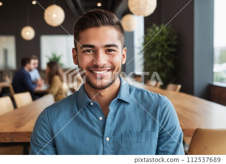 AI-generated content. A man in a blue shirt displays a relaxed, happy demeanor in an office cafe area with colleagues in the background. 112537689