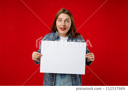 Beautiful 30s woman holding a blank advertisement banner isolated over red background. Young woman holding sign business board Beautiful 30s woman holding a blank advertisement banner isolated over red background. Young woman holding sign business board 112537989