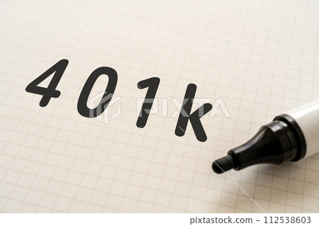 Notebook and marker with 401k written on it 112538603