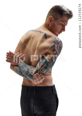 Rear view portrait of man holding hands behind back showing his muscular spine against white studio background. Copy space. Rear view portrait of man holding hands behind back showing his muscular spine against white studio background. Copy space. 112539274