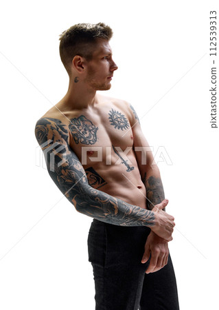 Portrait of tattooed young handsome man with muscular body looking away against white studio background. Copy space. 112539313