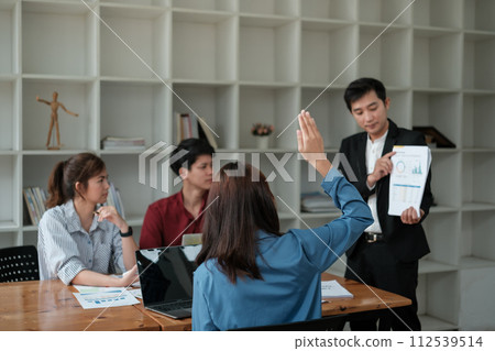 Business woman raising hand during seminar. Hand up in conference asking to answer question in business seminar class. Concept of conference, training, planning, learning, coaching, business. Business woman raising hand during seminar. Hand up in conference asking to answer question in business seminar class. Concept of conference, training, planning, learning, coaching, business. 112539514