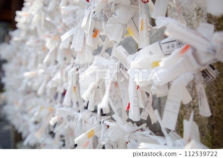 Prayer Papers Tied to Rope in Japanese Shrine - Spiritual Tradition and Sacred Offerings 112539722