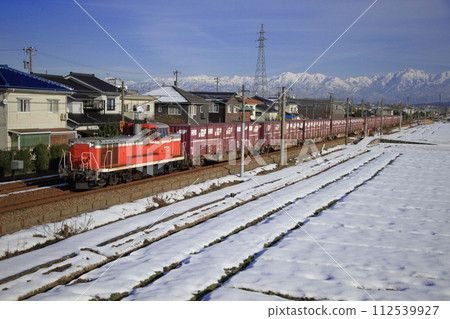 A freight train pulled by a DE10 diesel locomotive running on the scenic Hokuriku Main Line_Photo taken on December 28, 2014 A freight train pulled by a DE10 diesel locomotive running on the scenic Hokuriku Main Line_Photo taken on December 28, 2014 112539927