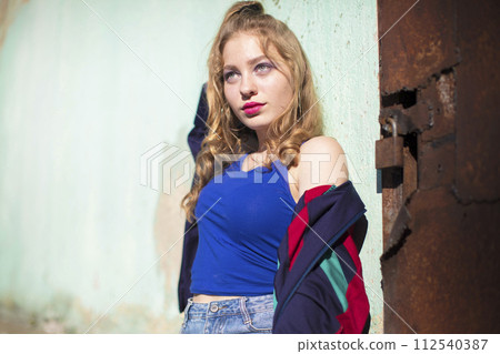 Beautiful girl in the style of the 90s in bright clothes. 112540387