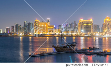 View from Katara Beach day to night timelapse in Doha, Qatar, towards the West Bay and city center 112540545