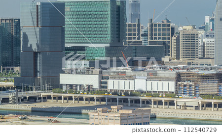 Buildings on Al Reem island in Abu Dhabi timelapse from above. 112540729