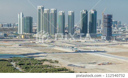 Buildings on Al Reem island in Abu Dhabi timelapse from above. Buildings on Al Reem island in Abu Dhabi timelapse from above. 112540732