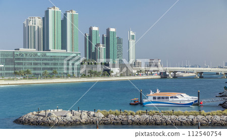 Modern buildings in Abu Dhabi skyline timelapse with waterfront. Modern buildings in Abu Dhabi skyline timelapse with waterfront. 112540754