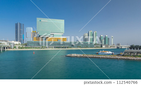 Modern buildings in Abu Dhabi skyline timelapse hyperlapse with waterfront. 112540766