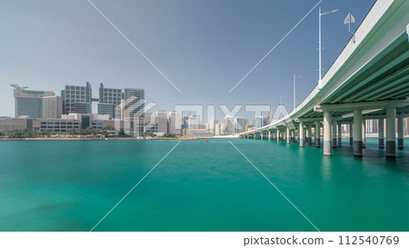 Modern buildings in Abu Dhabi skyline timelapse hyperlapse with mall and beach. 112540769