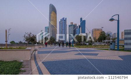 Skyscrapers in Abu Dhabi Skyline day to night timelapse, United Arab Emirates Skyscrapers in Abu Dhabi Skyline day to night timelapse, United Arab Emirates 112540794