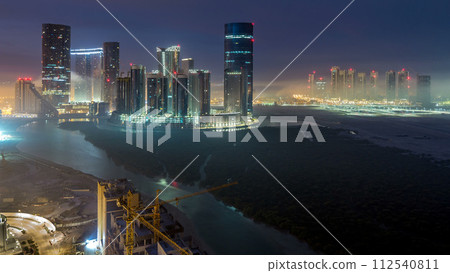 Buildings on Al Reem island in Abu Dhabi timelapse from above. Buildings on Al Reem island in Abu Dhabi timelapse from above. 112540811