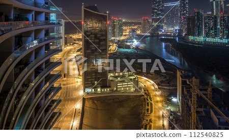 Buildings on Al Reem island in Abu Dhabi night timelapse from above. 112540825