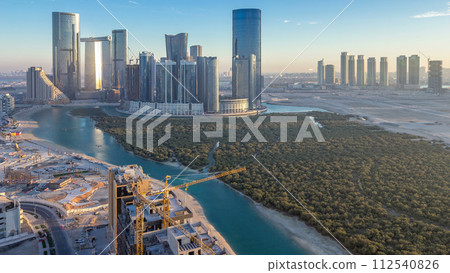 Buildings on Al Reem island in Abu Dhabi day to night timelapse from above. Buildings on Al Reem island in Abu Dhabi day to night timelapse from above. 112540826