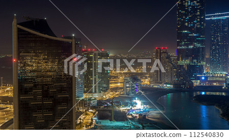 Buildings on Al Reem island in Abu Dhabi night timelapse from above. 112540830