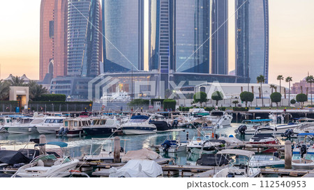 Al Bateen marina Abu Dhabi day to night timelapse with modern skyscrapers on background Al Bateen marina Abu Dhabi day to night timelapse with modern skyscrapers on background 112540953
