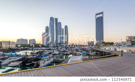 Al Bateen marina Abu Dhabi day to night timelapse with modern skyscrapers on background 112540971