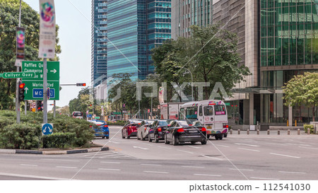 Traffic with cars on a street and urban scene in the central district of Singapore timelapse 112541030