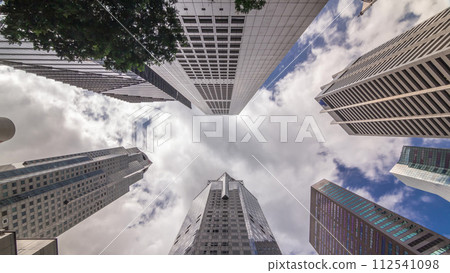 Looking up perspective of modern business skyscrapers glass and sky view landscape of commercial building in central city timelapse 112541098