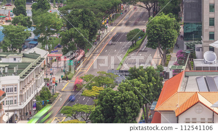 Traffic with cars on a street and urban scene in the central district of Singapore timelapse Traffic with cars on a street and urban scene in the central district of Singapore timelapse 112541106