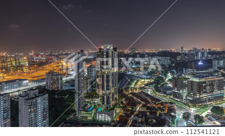 City skyline with commercial port of Singapore aerial night timelapse. 112541121