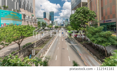 Traffic with cars on a street and urban scene in the central district of Singapore timelapse 112541181