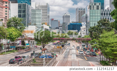 Traffic with cars on a street and urban scene in the central district of Singapore timelapse 112541217