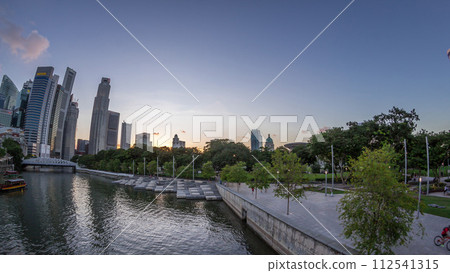 Singapore skyscrapers skyline with white Anderson Bridge near esplanade park day to night timelapse. Singapore skyscrapers skyline with white Anderson Bridge near esplanade park day to night timelapse. 112541315